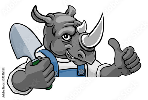 A rhino gardener cartoon gardening animal mascot holding a garden spade tool peeking round a sign and giving a thumbs up