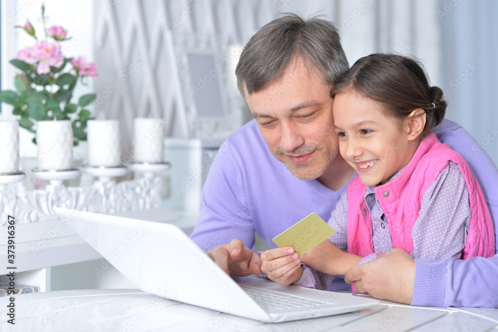 Close up portrait of father with little daughter using laptop Close up portrait of father with little daughter using laptop