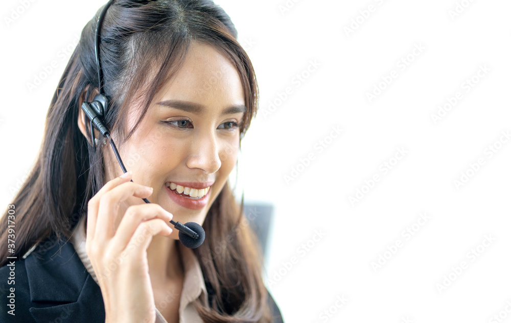 Smiling female customer support operator with headset working in office, Asian young woman working in call centre. Smiling female customer support operator with headset working in office, Asian young woman working in call centre.