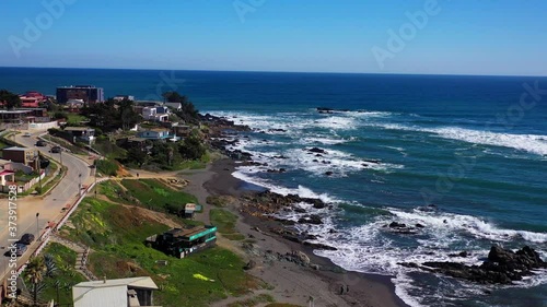 Aerial drone with a view of the beach and people and children playing with a general view of the houses on the beach location is infiernillo beach in pichilemu chile colchagua cardenal caro photo