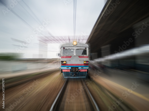 Front view of a moving train with zoom blur.