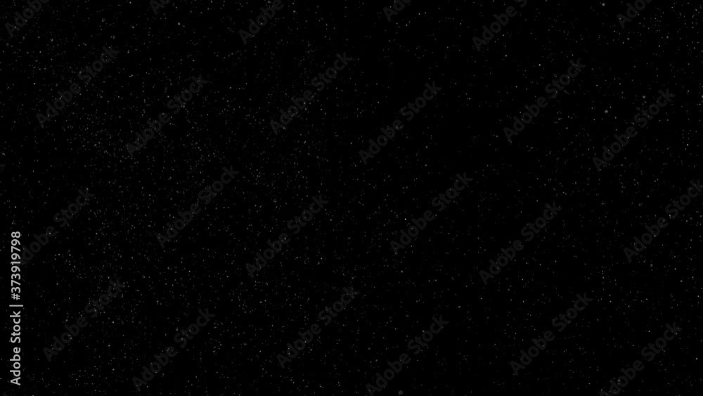 Dust particles sparkling on black background with mist sprinkling effect