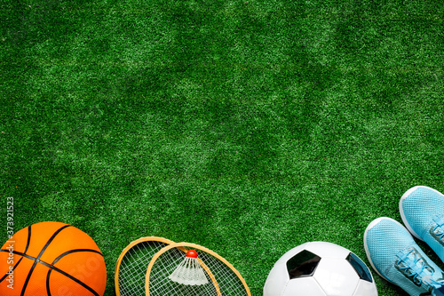 Flat lay of sport balls - football, basketball on grass. Top view copy space