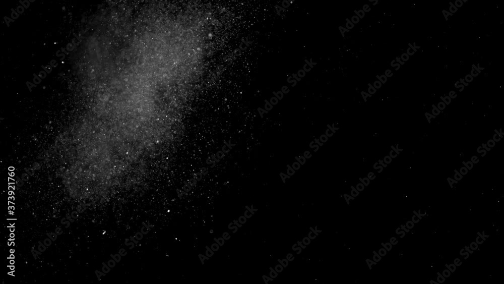 Dust particles sparkling on black background with mist sprinkling effect