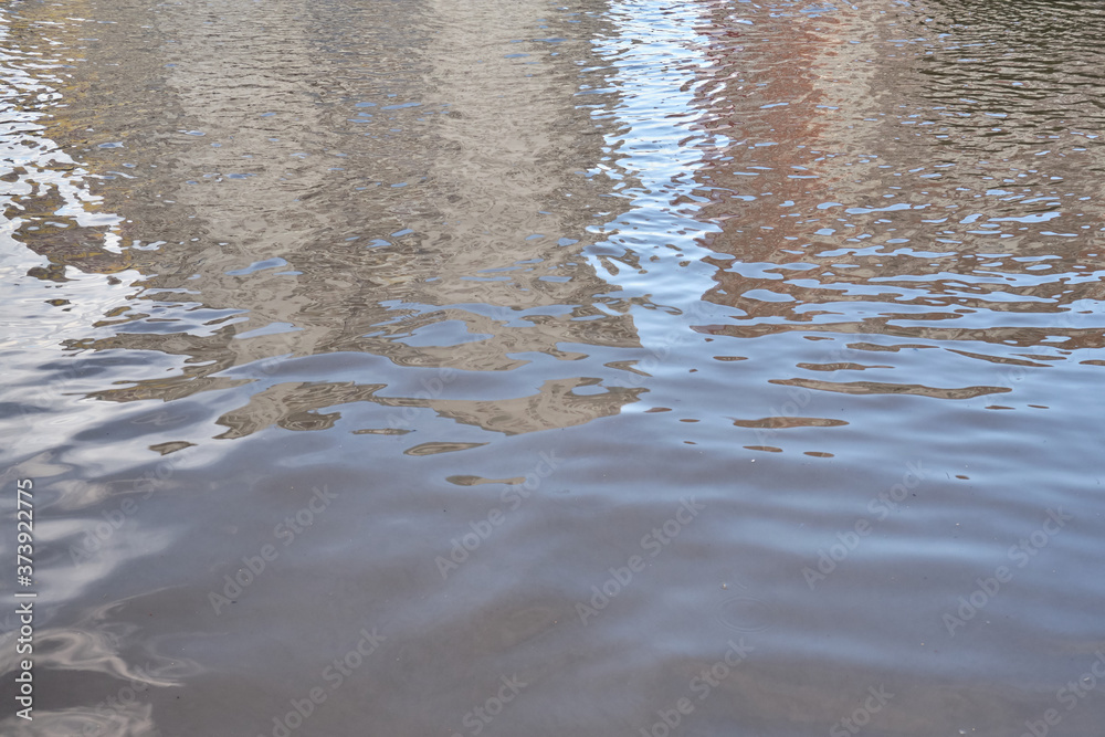 Big puddle in the city after rain. flood protection within the residential area of the urban community Big puddle in the city after rain. flood protection within the residential area of the urban community