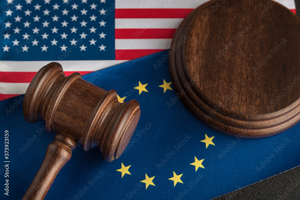Judge gavel over US flag and EU. Trade war. Legal confrontation United States of America and European Union