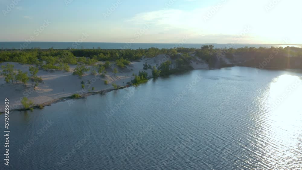 Aerial shot over the sand dunes and the Ontario lake at sunset Aerial shot over the sand dunes and the Ontario lake at sunset