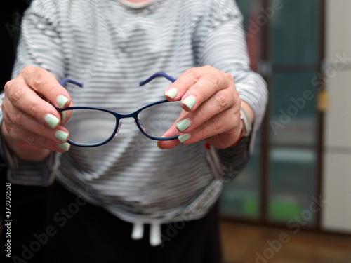 spectacles in female hands
