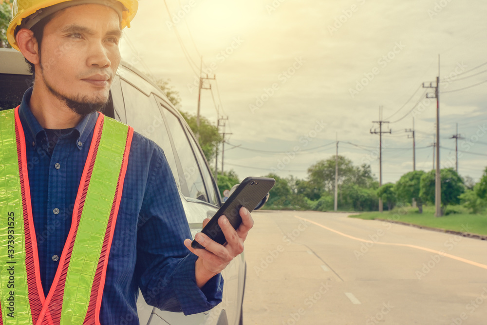 Asian man Engineer holding mobile phone survey on site construction outdoor Asian man Engineer holding mobile phone survey on site construction outdoor