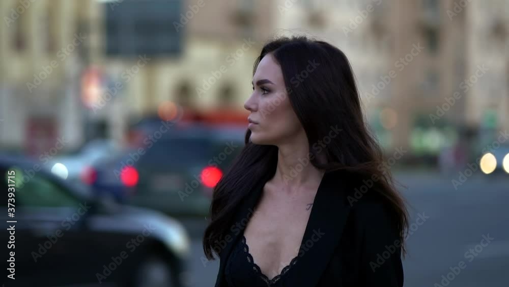 fashion model woman is walking in twilight on city street, medium portrait fashion model woman is walking in twilight on city street, medium portrait