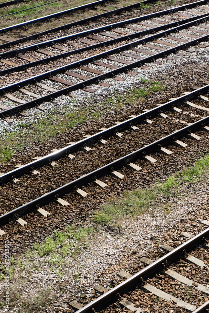 Railway top view background. Train transport industry. Vertical rail track texture. Good and cheap way of transportation for cargo. Old railroad wooden tie. Track ballast gravel made of crushed stone. Railway top view background. Train transport industry. Vertical rail track texture. Good and cheap way of transportation for cargo. Old railroad wooden tie. Track ballast gravel made of crushed stone.