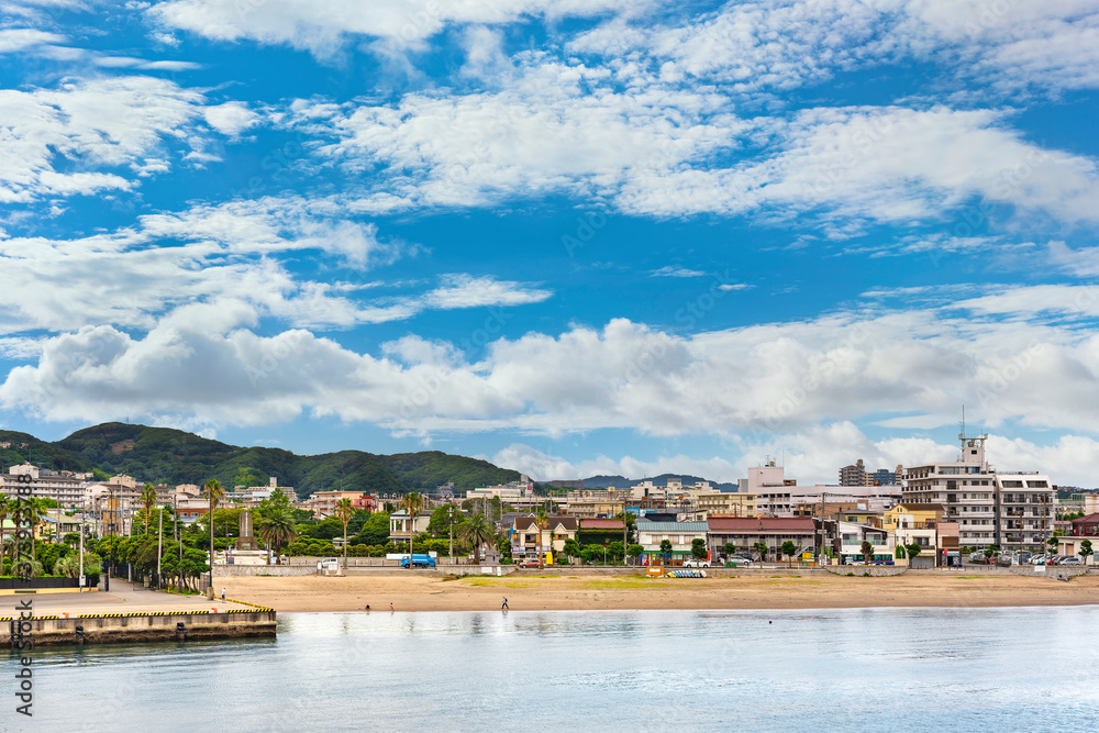 Obraz premium Coast of Miura Peninsula with palm fringed Kurihama beach in Yokosuka town facing the Uraga Channel off the Tokyo bay.