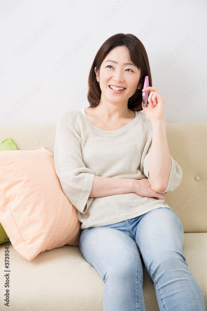 Obraz premium 電話するミドル女性