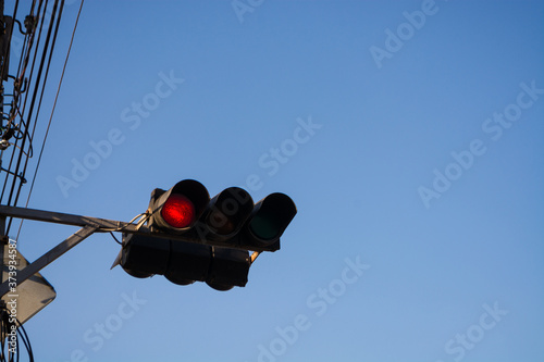 Horizontal red traffic light in the blue sky background