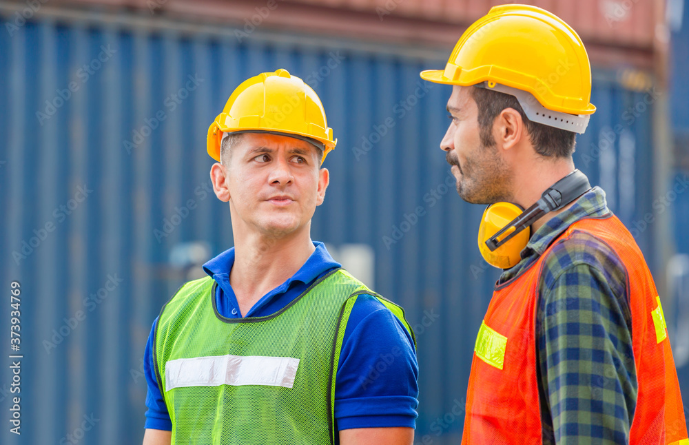 Engineer and factory worker team checking containers box from cargo with blurred background, Teamwork concept Engineer and factory worker team checking containers box from cargo with blurred background, Teamwork concept