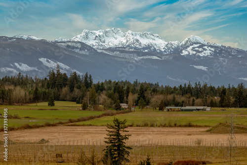  Mount Arrowsmith with snow and valley view with trees and field