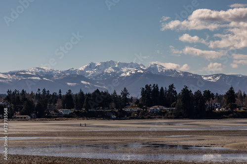 snow-covered mountains Mount Arrowsmith view from a sandy beach Parksville photo