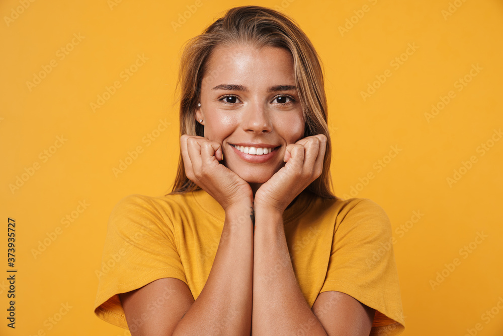 Image of blonde joyful woman smiling and looking at camera Image of blonde joyful woman smiling and looking at camera