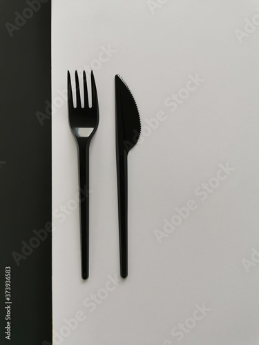 black fork and knife isolated on black and white background
