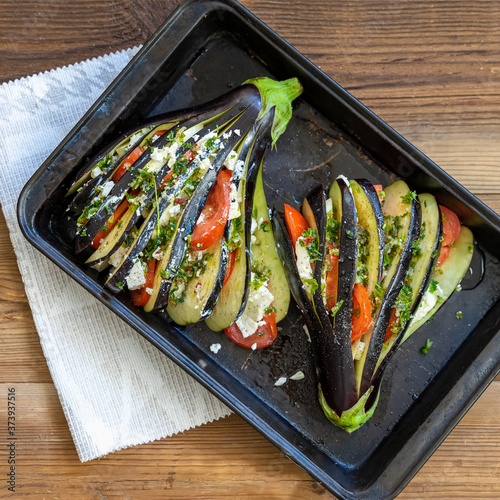 Stuffed eggplants with vegetables on the baking tray, top view. Homemade preparation. Vegetable, vegetarian diet