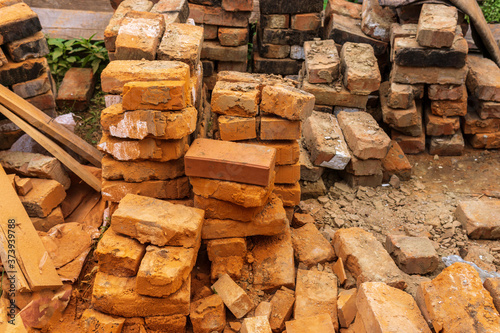 piles of brick, Red brick for building houses. Many used wall bricks laid on a pile