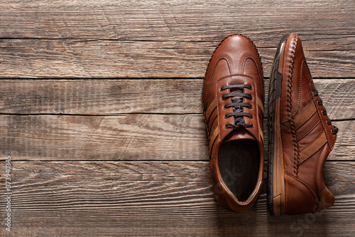 Leather sneakers on wooden background