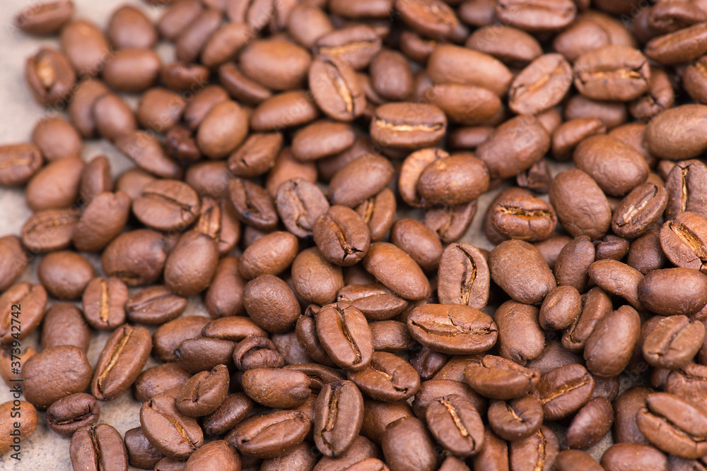 Roasted coffee beans on a textured background, empty copy space Roasted coffee beans on a textured background, empty copy space