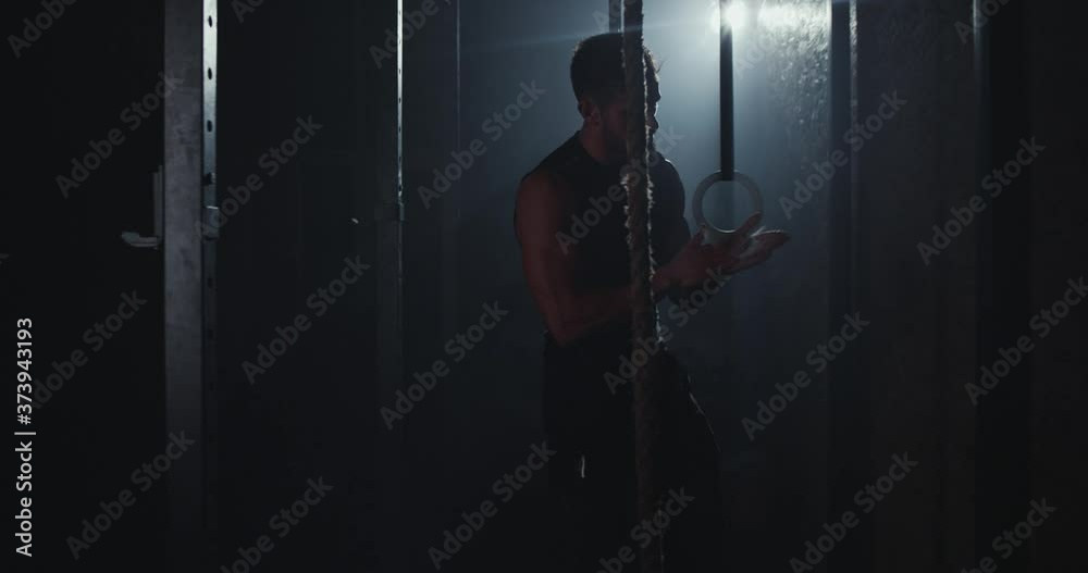 In the dark cross fitness class bodybuilding man using powder and start to doing his intense workout training In the dark cross fitness class bodybuilding man using powder and start to doing his intense workout training