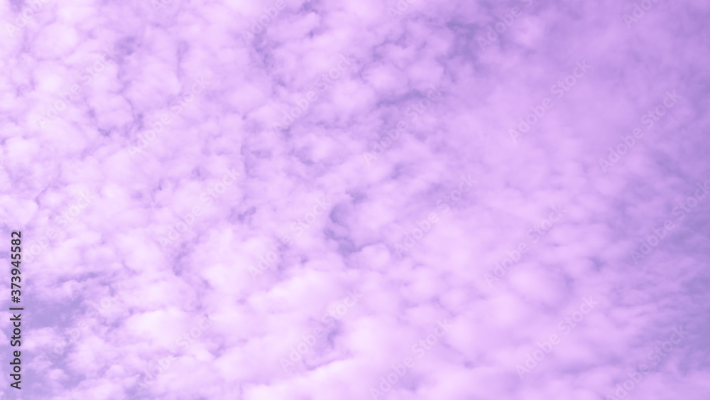 Blur purple clouds sky as abstract background. Violet fluffy cloudscape texture.