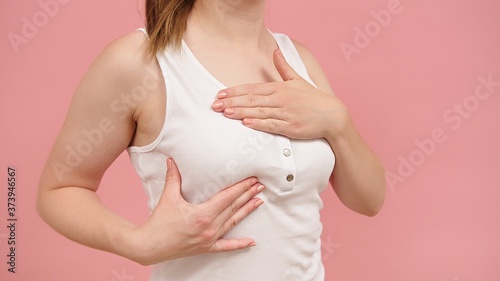 Wallpaper Mural Health and body care. Self examination of the breasts, breast cancer awareness concept. Isolated on pink background. High quality photo Torontodigital.ca