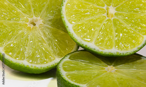 Slices of fresh and juice lime fruits, full frame
