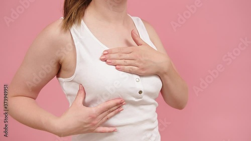 Wallpaper Mural Health and body care. Self examination of the breasts, breast cancer awareness concept. Isolated on pink background. High quality 4k footage Torontodigital.ca