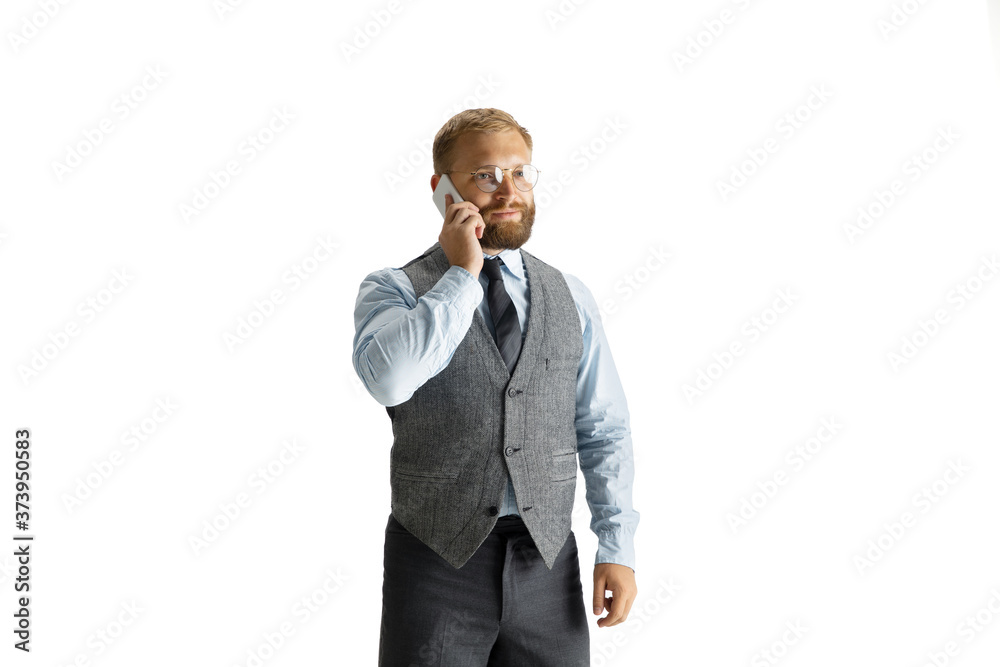 Cheerful handsome businessman isolated over white studio background, copyspace. Modern young director, manager in office suit, full length portrait. Using devices, gadgets. Business, finance, tech Cheerful handsome businessman isolated over white studio background, copyspace. Modern young director, manager in office suit, full length portrait. Using devices, gadgets. Business, finance, tech
