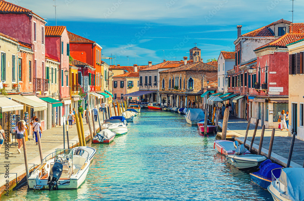 Murano islands with water canal, boats and motor boats, colorful traditional buildings, Venetian Lagoon, Province of Venice, Veneto Region, Northern Italy. Murano postcard cityscape.