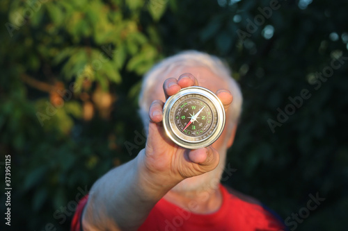 Round classic compass in hand of man