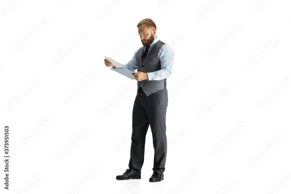 Cheerful handsome businessman isolated over white studio background, copyspace. Modern young director, manager in office suit, full length portrait. Paperwork. Business, finance, tech concept. Cheerful handsome businessman isolated over white studio background, copyspace. Modern young director, manager in office suit, full length portrait. Paperwork. Business, finance, tech concept.