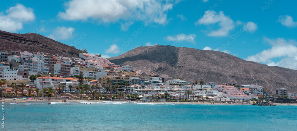 Naklejka premium Panoramic view of the tropical Playa de Las Vistas, one of the most popular beaches in the south of the island with friendly waves and fine sand, nearby Los Cristianos, Tenerife, Canary Islands, Spain