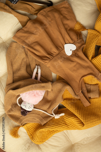 Baby autumn style clothes concept of child fashion. Flat lay children's clothing and accessories. Baby template background with copy space. Top view fashion trendy look of baby clothes and toy stuff.