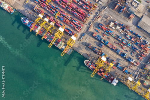 Container , container ship in export and import business and logistics. Shipping cargo to harbor by crane. Water transport International. Aerial view and top view.