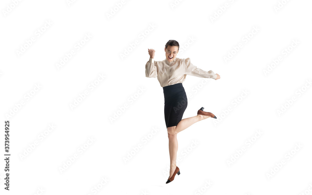 Beautiful business woman, secretary, manager on white studio background. Beautiful caucasian female model in office attire. Copyspace for ad, Concept of business, finance, occupation. Dancing, jumping