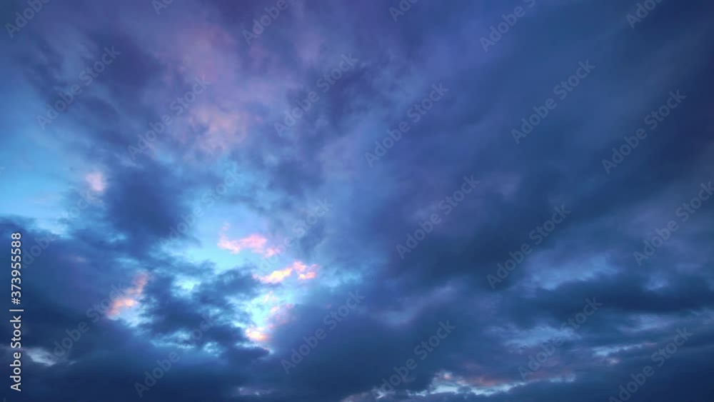 Time lapse of white clouds on a sky during sunset and sunrise Time lapse of white clouds on a sky during sunset and sunrise