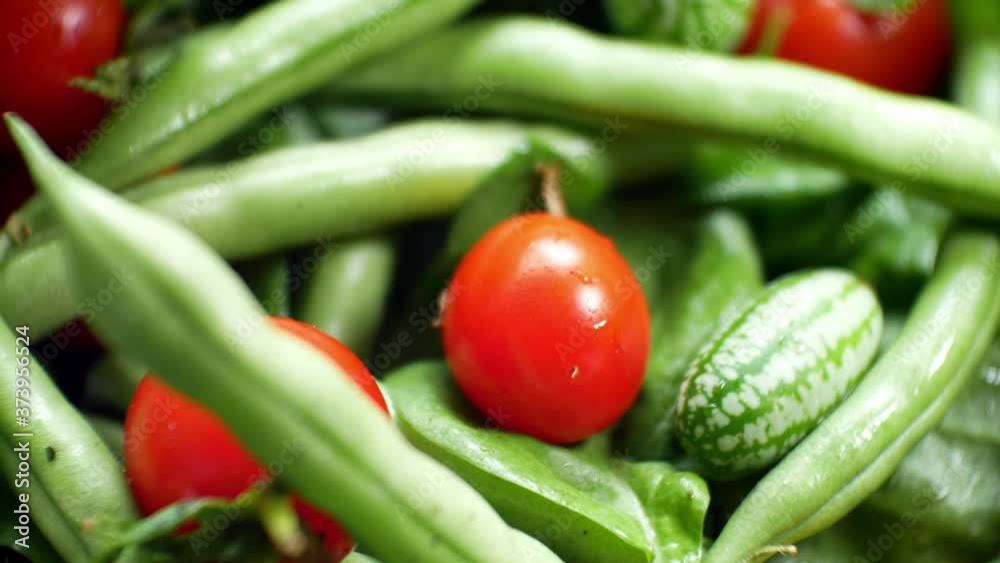 Shallow focus healthy fresh green spinach leaf cucamelon cherry tomato salad bowl closeup top down dolly left Shallow focus healthy fresh green spinach leaf cucamelon cherry tomato salad bowl closeup top down dolly left