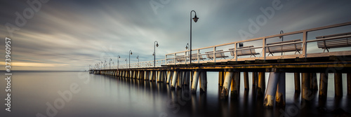 Amazing colorful sunrise over the pier in Gdynia Orlowo. Panoramic banner