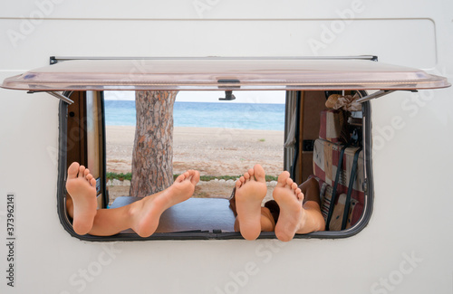 Fotografia Window of a camper van. In the window there are four legs