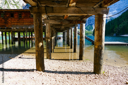 under the wooden pier of an alpine lake