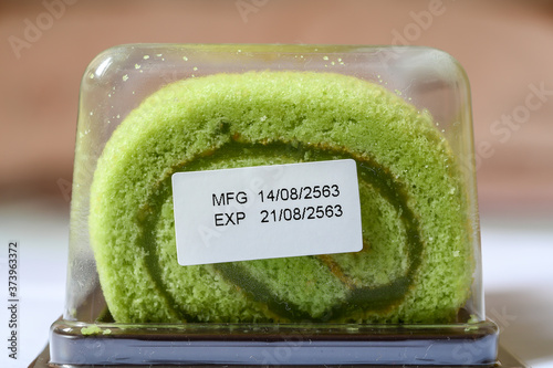 Pandan flavor roll cake in package with expiry date tag photo