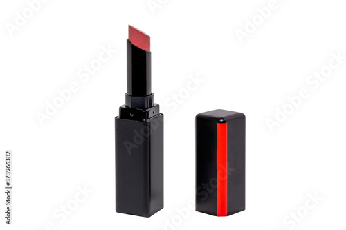 Pink lipstick isolated. Closeup of a elegant opened red lipstick in a black and red package isolated on a white background. Concept beauty. Macro.