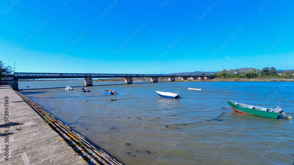 Fao / Esposende / Portugal -  August 22, 2020: The Fao metallic bridge, known as D. Luís Filipe Bridge. It is located at Fao in Braga District, crossing the Cávado River. The riverside promenade.