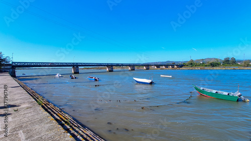 Fao / Esposende / Portugal -  August 22, 2020: The Fao metallic bridge, known as D. Luís Filipe Bridge. It is located at Fao in Braga District, crossing the Cávado River. The riverside promenade.