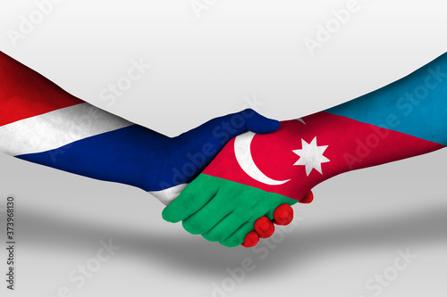 Handshake between azerbaijan and thailand flags painted on hands, illustration with clipping path.